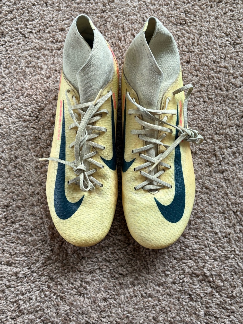 Nike women’s Yellow Soccer cleats with black Swoosh